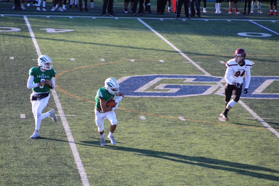 Matthew carrying the ball for Endicott in a game