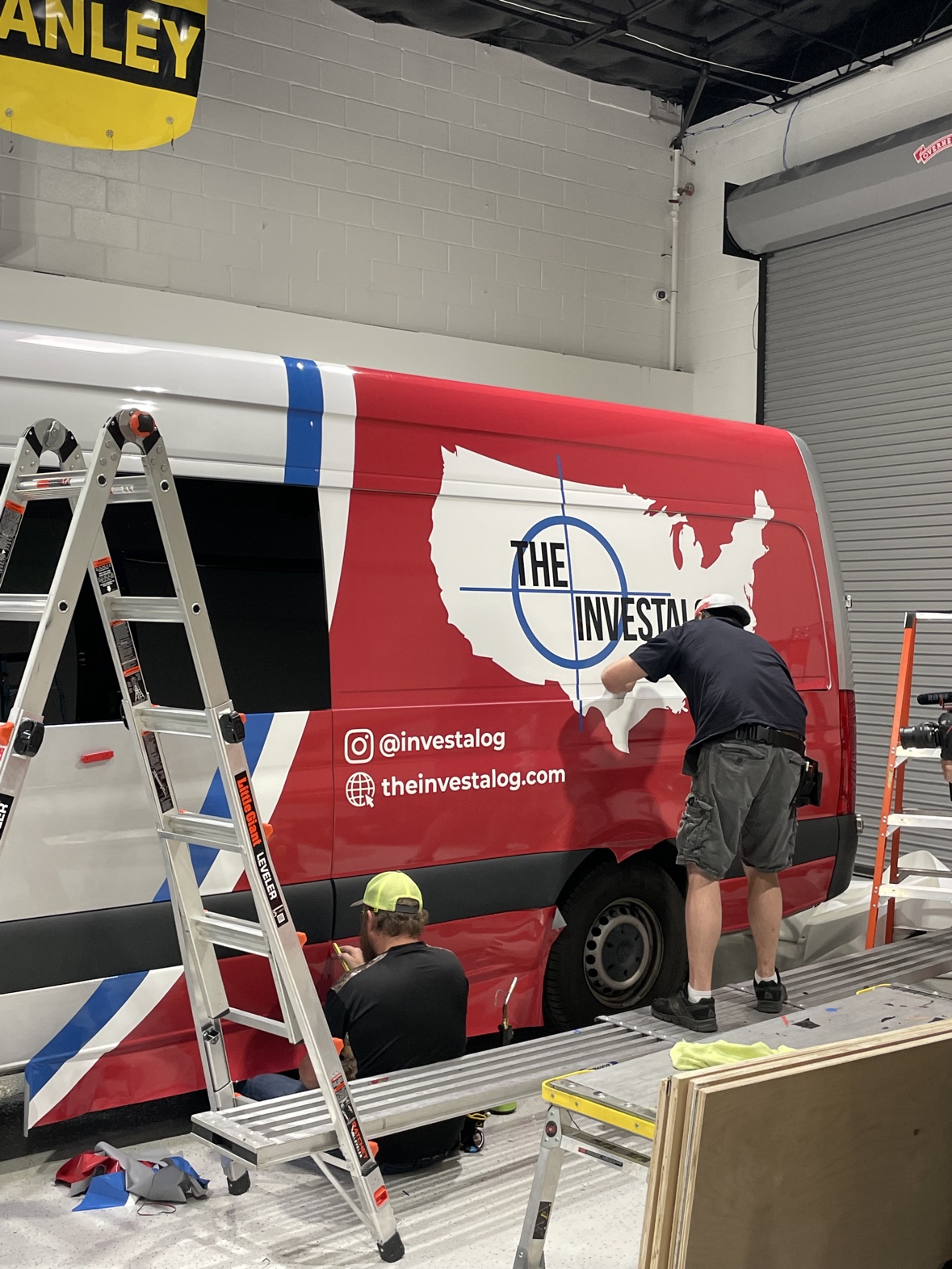 Red tour van getting its Investalog wrap