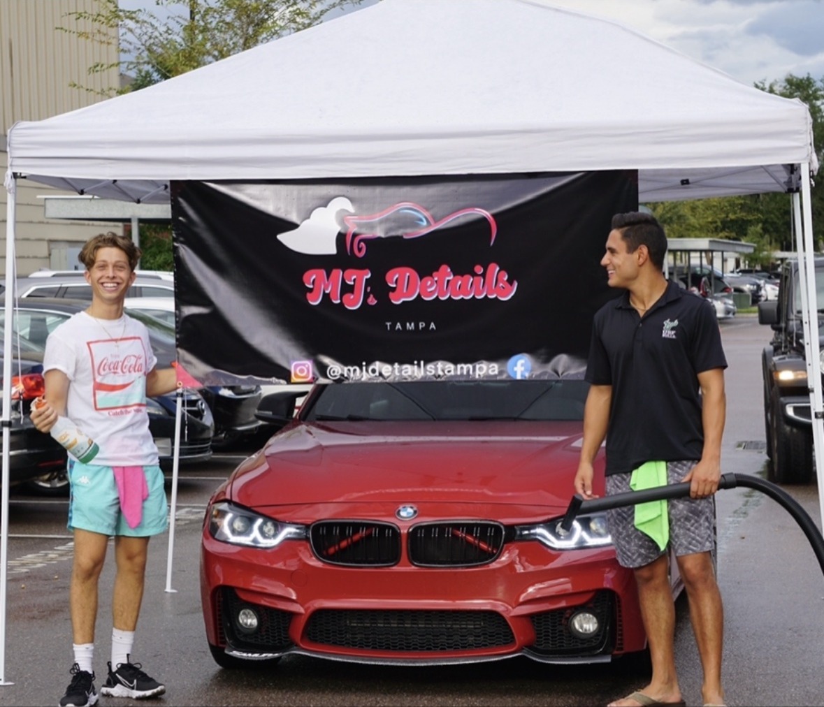 MJ Details Tampa tent with a red BMW, Matthew holding the vacuum hose