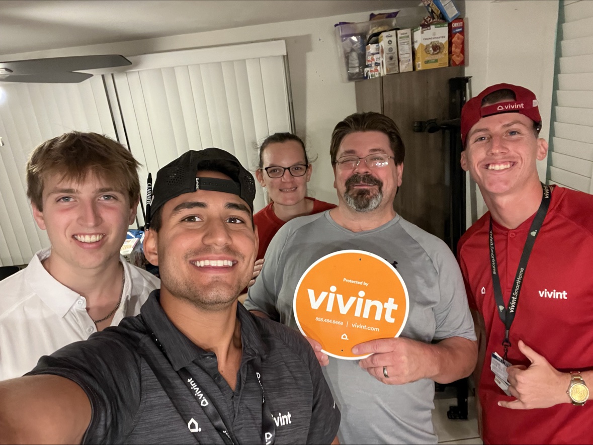 Group selfie with a customer family and a teammate